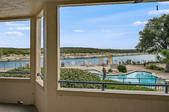 exterior space featuring a water view and a patio