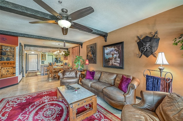 living room featuring ceiling fan with notable chandelier, a textured ceiling, light tile patterned floors, and beamed ceiling