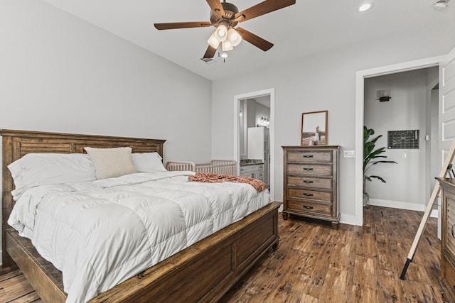 bedroom featuring ceiling fan, dark hardwood / wood-style flooring, and ensuite bathroom