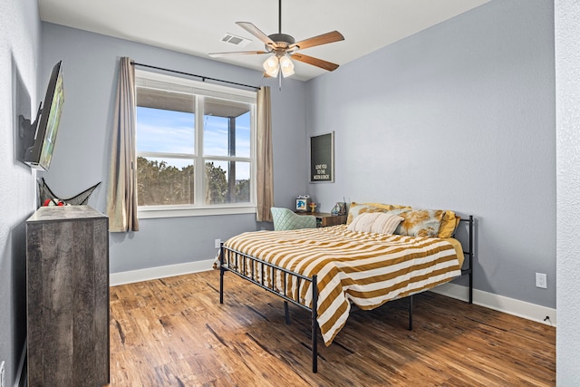 bedroom with ceiling fan and hardwood / wood-style floors