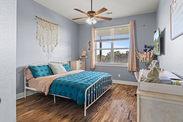 bedroom featuring ceiling fan and dark hardwood / wood-style flooring