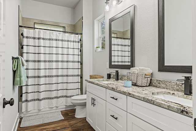 full bathroom featuring hardwood / wood-style floors, toilet, vanity, and shower / bathtub combination with curtain