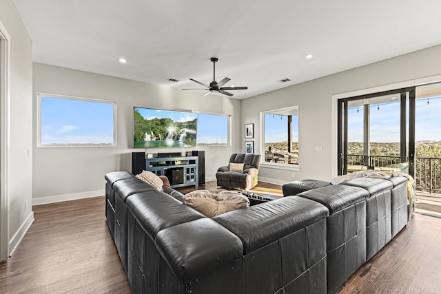 living room with ceiling fan and dark hardwood / wood-style floors