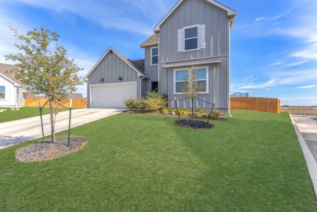 view of front facade featuring a front yard and a garage