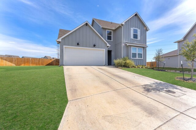 view of front facade featuring a front lawn and a garage