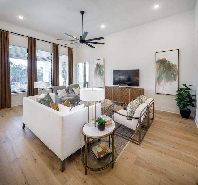 living room featuring light wood-type flooring and ceiling fan