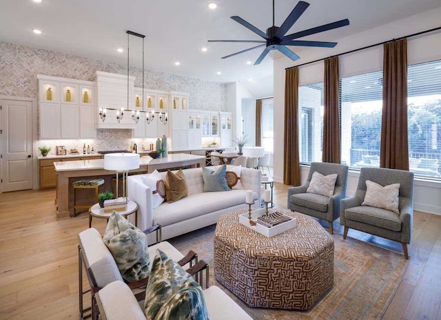 living room with ceiling fan and light wood-type flooring