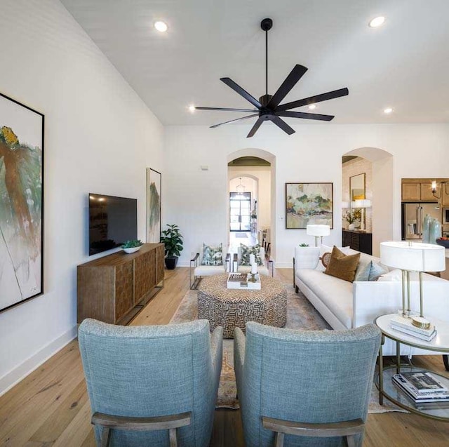 living room featuring ceiling fan and light hardwood / wood-style floors