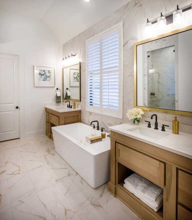 bathroom with independent shower and bath, lofted ceiling, and vanity