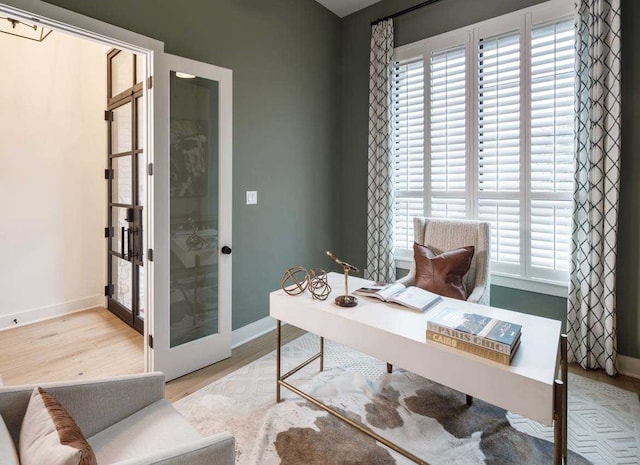 office featuring light hardwood / wood-style flooring and french doors