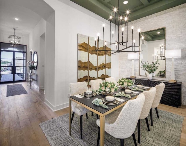 dining space with a high ceiling and hardwood / wood-style flooring