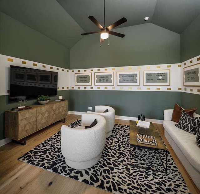 living room featuring ceiling fan, light hardwood / wood-style floors, and high vaulted ceiling