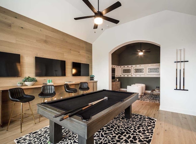 rec room featuring vaulted ceiling, light hardwood / wood-style floors, pool table, and wood walls