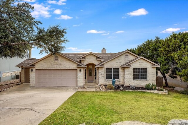 single story home featuring a front yard, a garage, and central AC unit