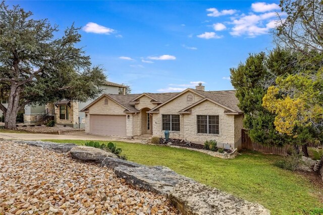 ranch-style house with a garage and a front yard