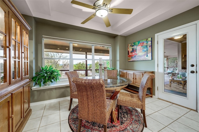 tiled dining space featuring ceiling fan