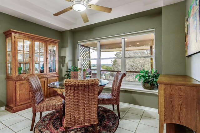 dining space featuring ceiling fan and light tile patterned floors