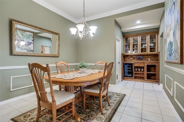 tiled dining space with ornamental molding, beverage cooler, and a chandelier