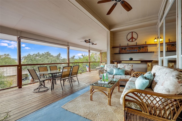 sunroom / solarium featuring ceiling fan