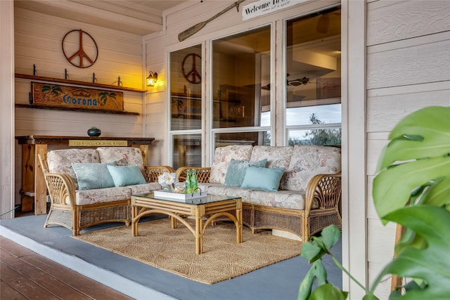 living area with hardwood / wood-style floors and wood walls