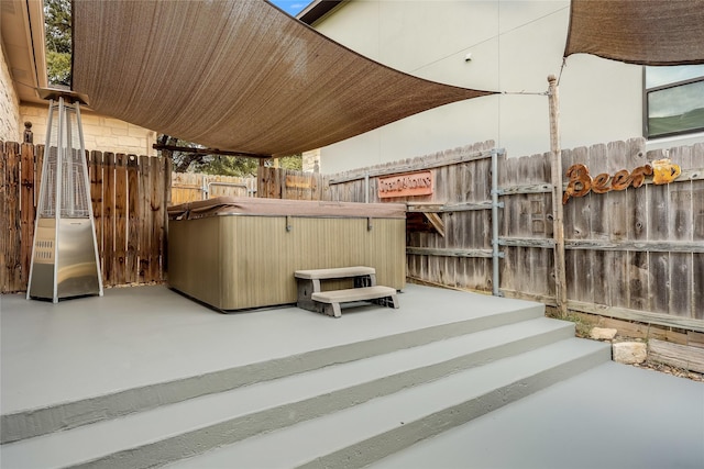 view of patio with a hot tub