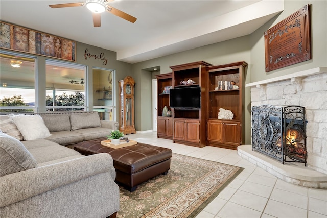 living room with ceiling fan, light tile patterned floors, and a fireplace