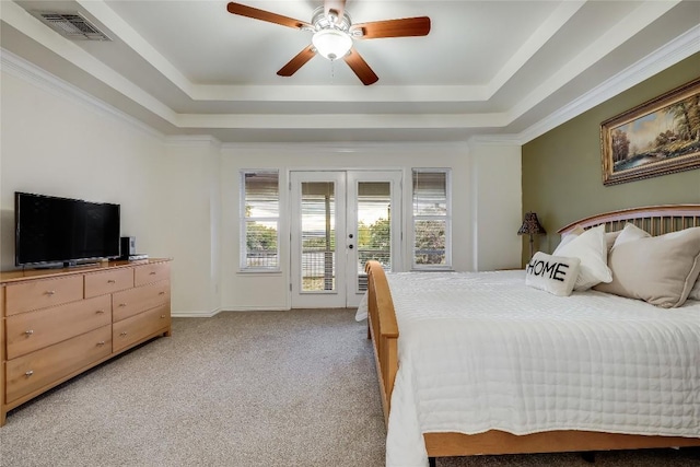 carpeted bedroom featuring french doors, ceiling fan, a raised ceiling, and access to outside