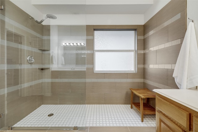 bathroom with vanity, tile patterned floors, and tiled shower