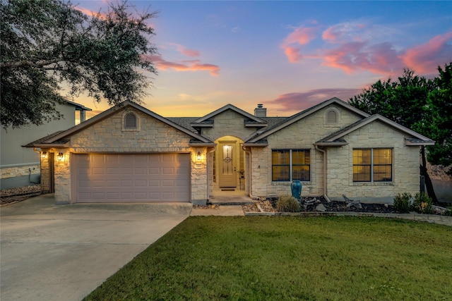 view of front of home featuring a garage and a lawn