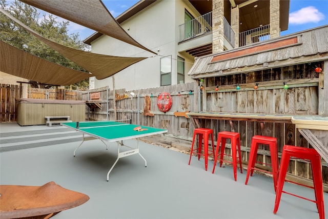 rec room with concrete flooring