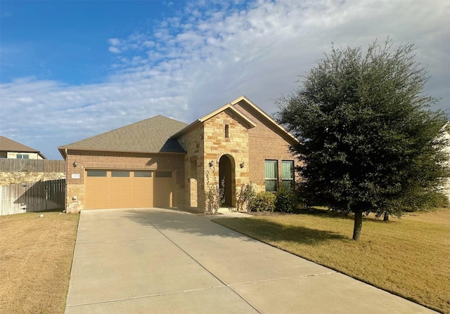 view of front of home with a front yard and a garage