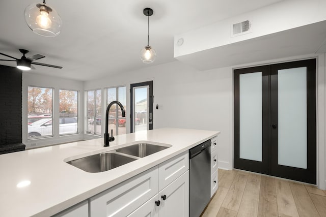 kitchen with pendant lighting, white cabinets, sink, ceiling fan, and stainless steel dishwasher