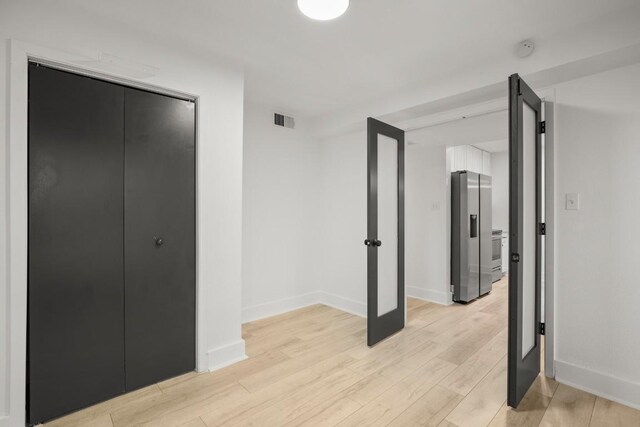 909 Reinli St Unit 103, Austin, TX 78751 - unfurnished bedroom featuring stainless steel refrigerator with ice dispenser and light wood-style floors