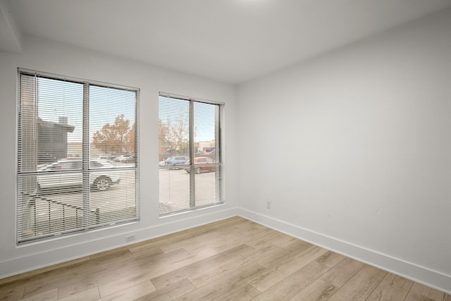 spare room with light hardwood / wood-style floors