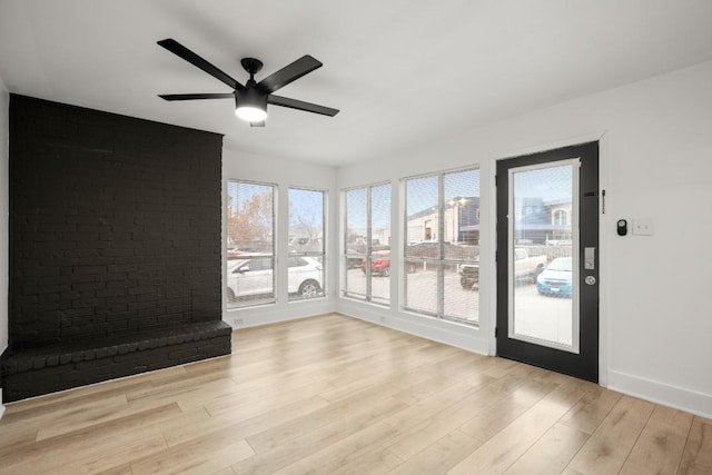 909 Reinli St Unit 103, Austin, TX 78751 - empty room featuring healthy amount of natural light, a ceiling fan, and wood finished floors