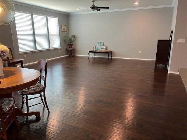 living area featuring dark wood-type flooring, ceiling fan, and crown molding