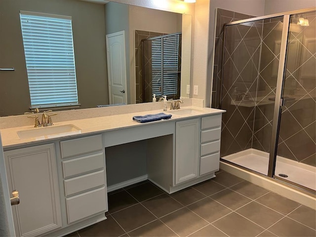 bathroom featuring vanity, tile patterned flooring, and a shower with door