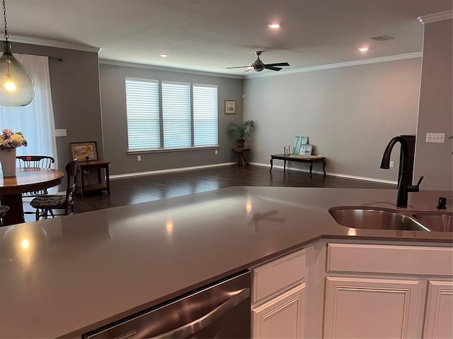 kitchen with decorative light fixtures, white cabinetry, ornamental molding, ceiling fan, and stainless steel dishwasher