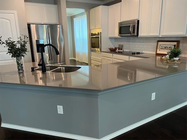 kitchen with kitchen peninsula, white cabinets, and stainless steel appliances