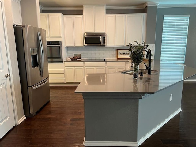 kitchen featuring decorative backsplash, sink, dark wood-type flooring, appliances with stainless steel finishes, and white cabinets