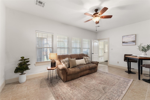 living room with ceiling fan and light tile patterned floors