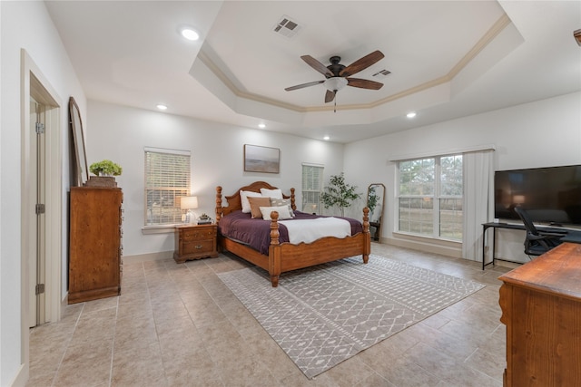 bedroom with a raised ceiling, ceiling fan, and ornamental molding