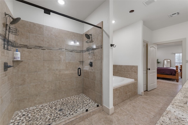 bathroom with tile patterned floors and independent shower and bath