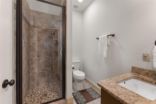 bathroom featuring toilet, vanity, and walk in shower