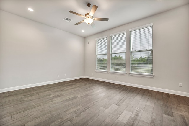 unfurnished room with ceiling fan and dark wood-type flooring