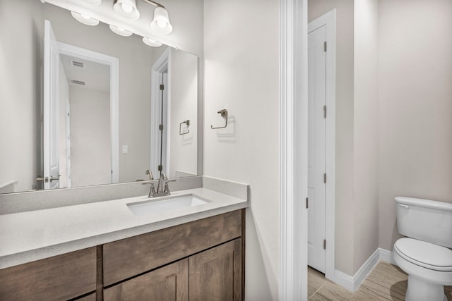 bathroom with toilet and vanity