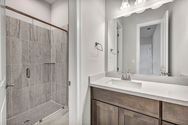 bathroom featuring walk in shower and vanity