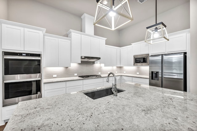 kitchen featuring stainless steel appliances, white cabinets, and sink