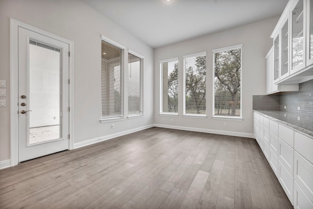 unfurnished dining area with light wood-type flooring