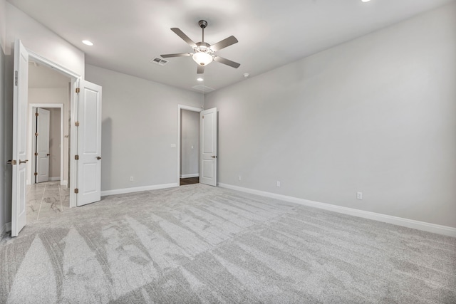 unfurnished bedroom with ceiling fan and light colored carpet